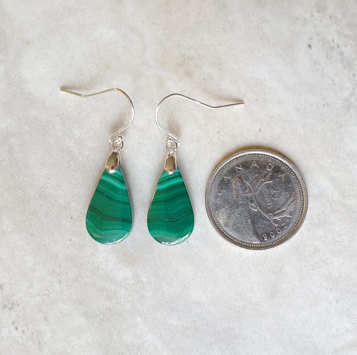 Malachite teardrop sterling silver earrings beside a quarter