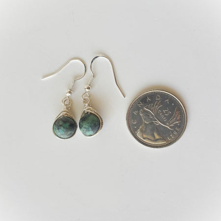 African Turquoise herringbone wrapped earrings beside a quarter