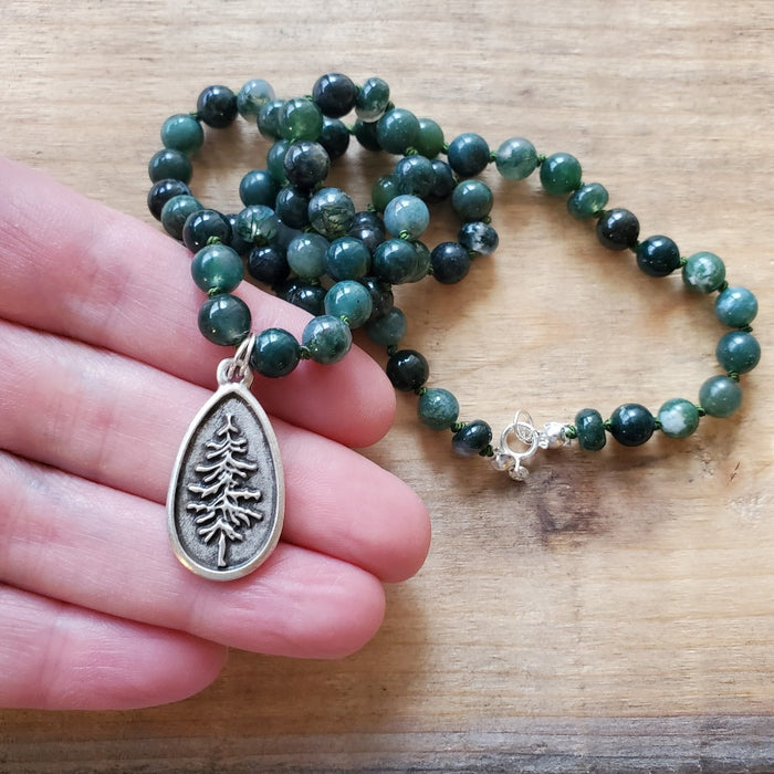 Hand knotted green moss agate necklace in hand