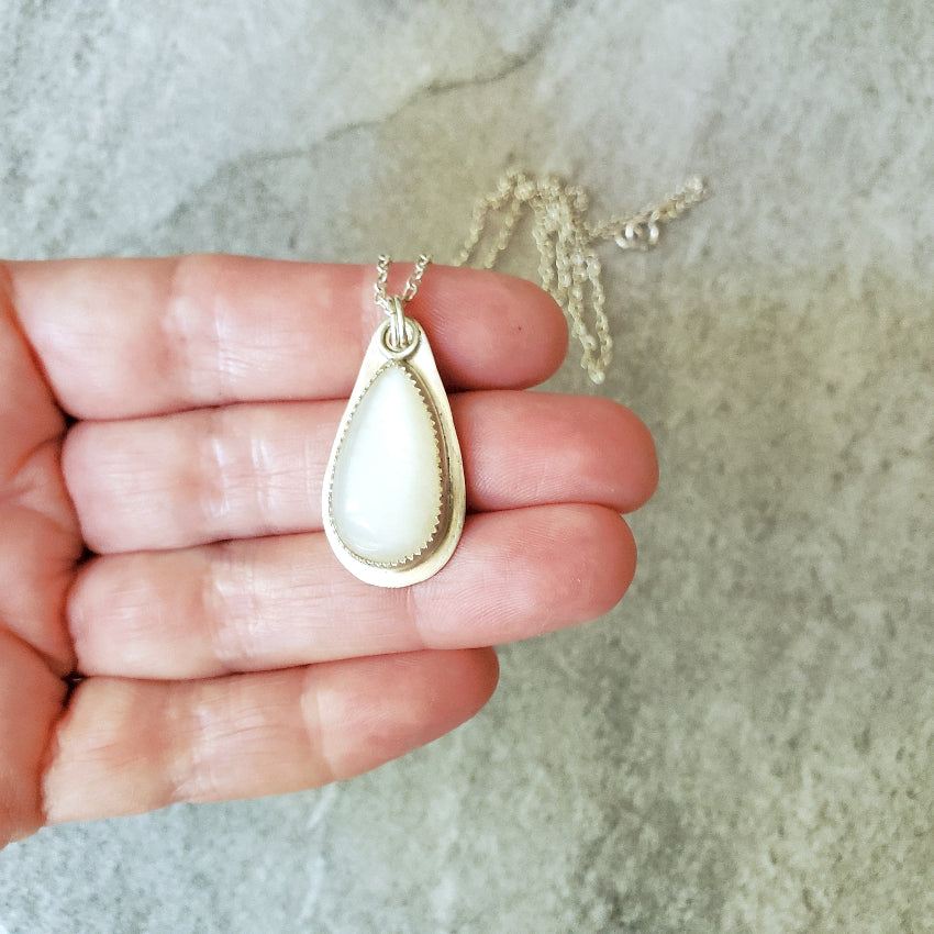 Moonstone silversmith pendant in hand
