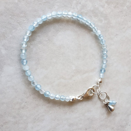 Faceted 3mm Aquamarine beaded bracelet on tile