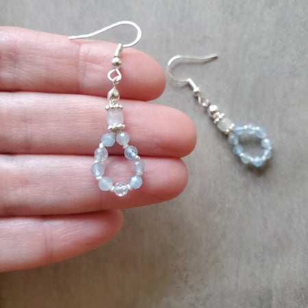 silk knotted Aquamarine and moonstone earrings  in hand