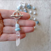 Aquamarine and crystal long hand knotted necklace in hand