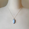 Blue Opal oval pendant set in silver on bust