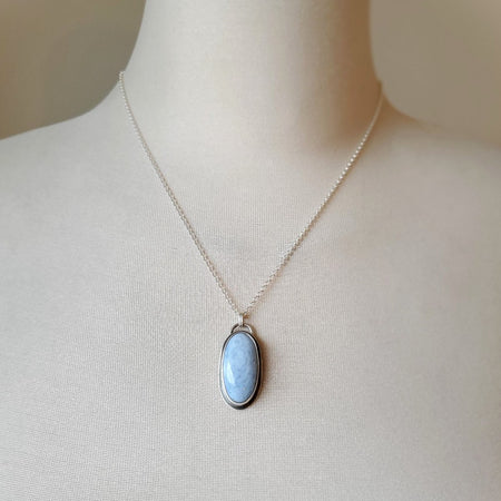 Blue Opal oval pendant set in silver on bust