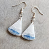Blue Scheelite gemstone earrings on wood