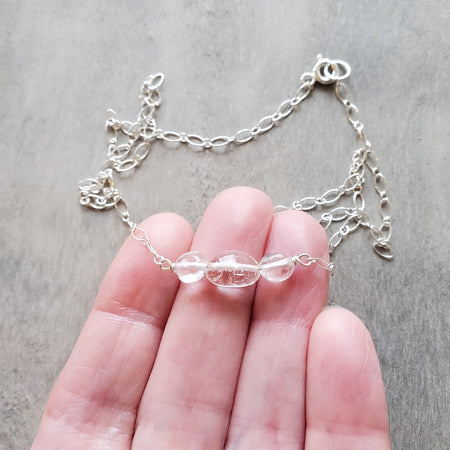 Clear Quartz Crystal bar necklace in hand