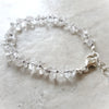 Clear quartz crystal hand knotted bracelet on tile 
