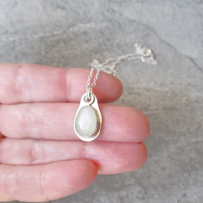 faceted white moonstone sterling silver pendant in hand