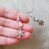 snowflake charm clear quartz dangle earrings in hand