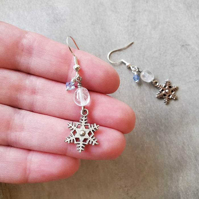 snowflake charm clear quartz dangle earrings in hand
