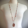 Multi gemstone long knotted necklace on bust 