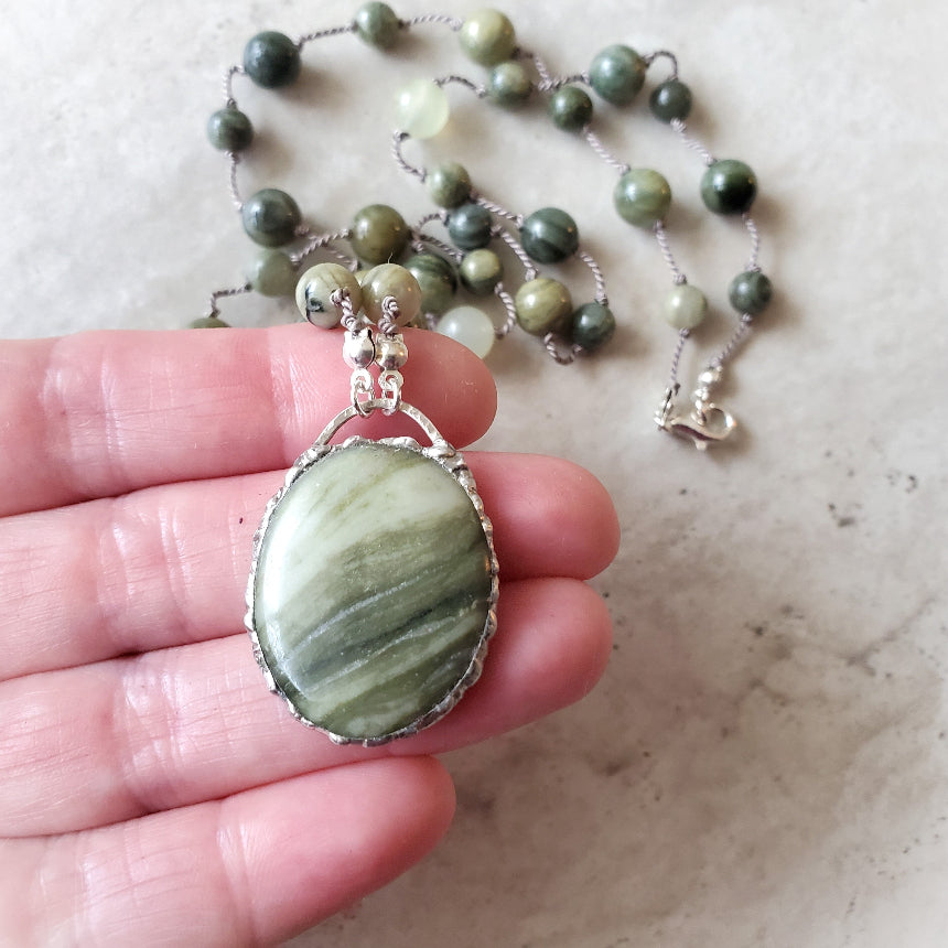 Serpentine and Green Line Quartz knotted necklace in hand