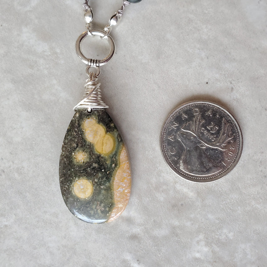 Ocean Jasper & African Jade long knotted necklace beside a quarter