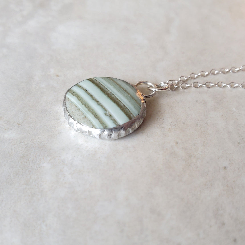 Green Saturn Chalcedony Round pendant necklace detail on tile