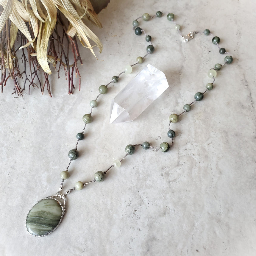 Serpentine and Green Line Quartz knotted necklace on tile 