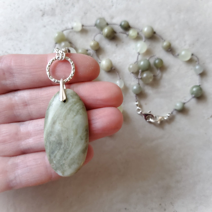 Beaded gemstone necklace with Serpentine focal in hand