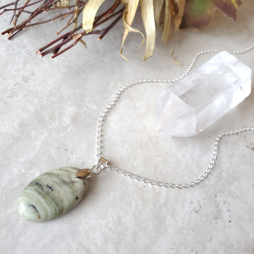 Serpentine oval pendant necklace on tile 