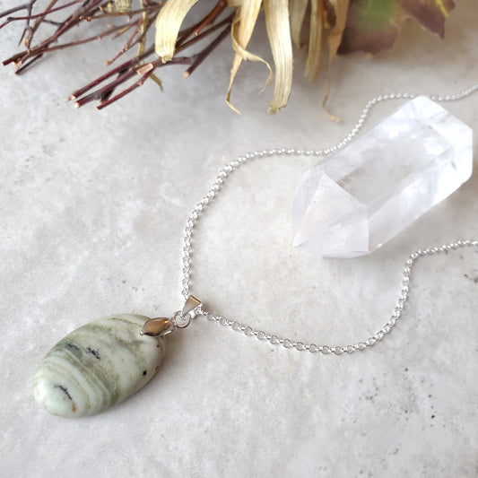 Serpentine oval pendant necklace on tile 