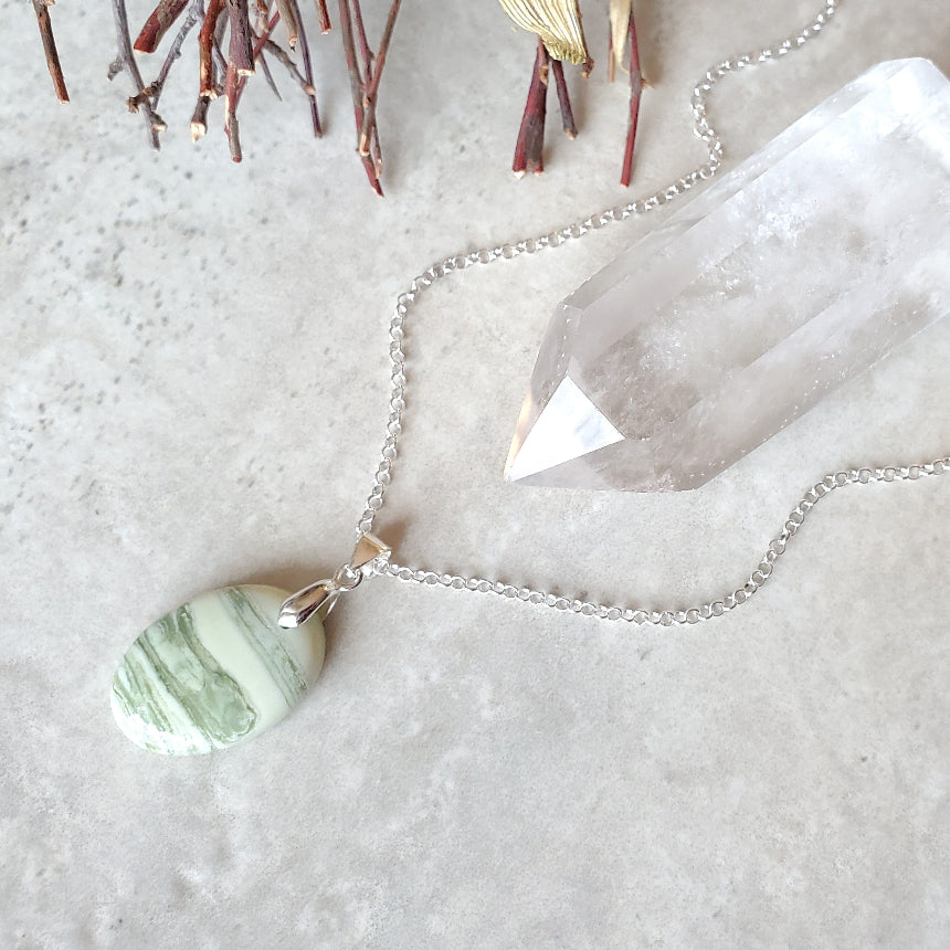 Serpentine oval pendant necklace on tile