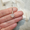 Moonstone heart earrings in hand