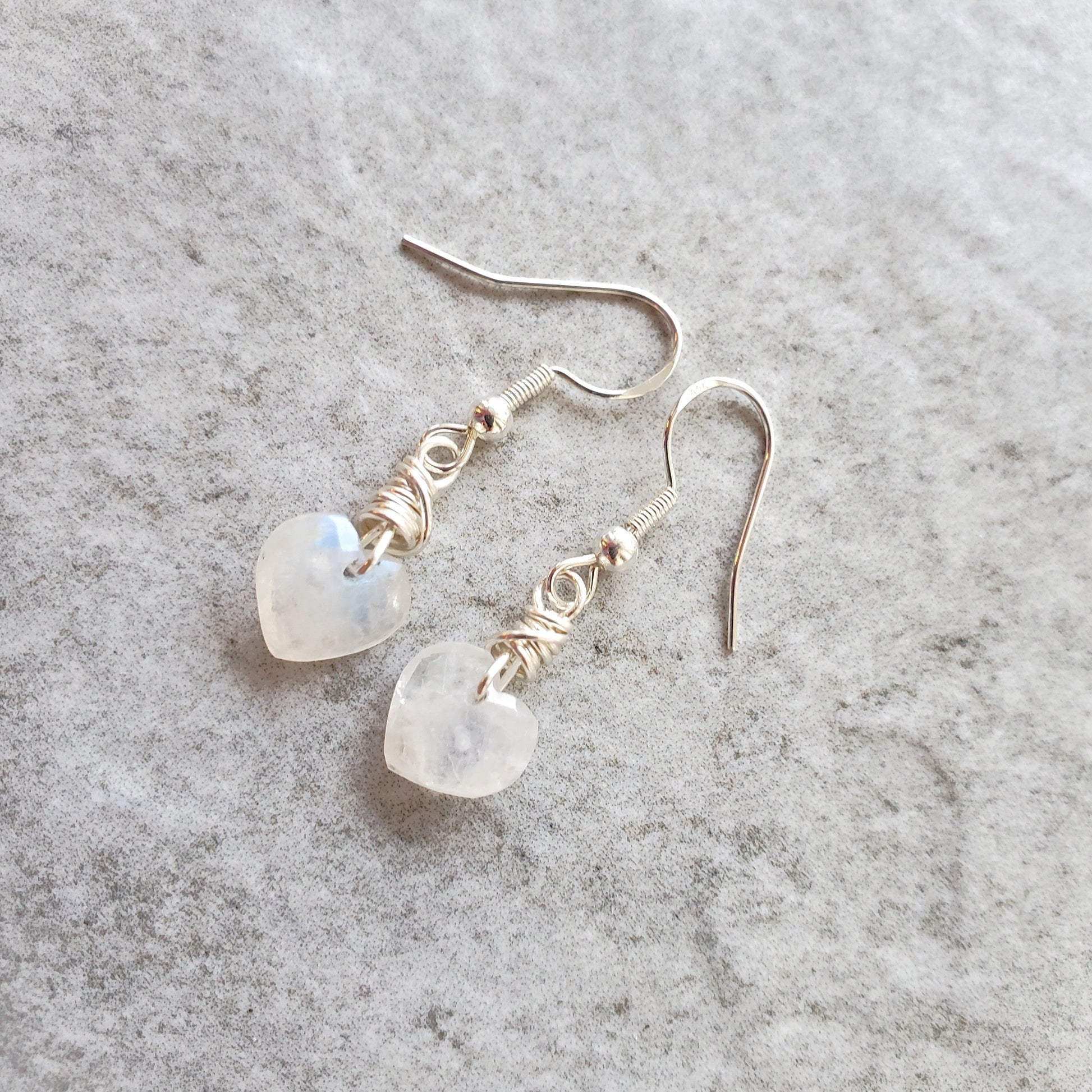 Moonstone heart earrings on tile