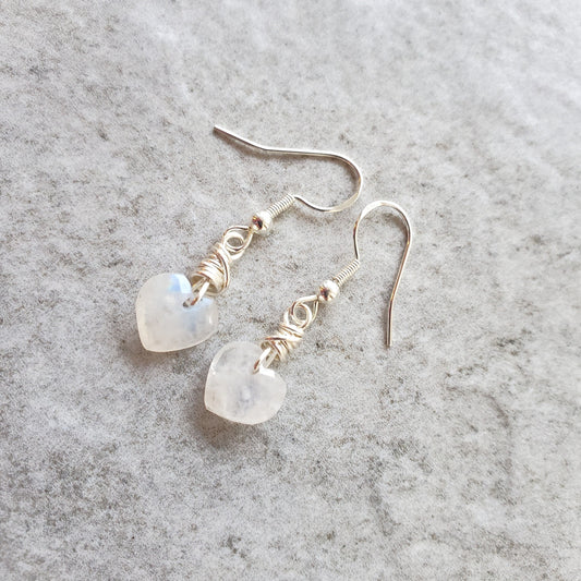 Moonstone heart earrings on tile