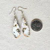 Freeform nugget Ocean Jasper earrings beside a quarter