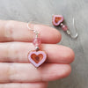 earrings of pink Czech glass hearts with Strawberry Quartz beads in hand