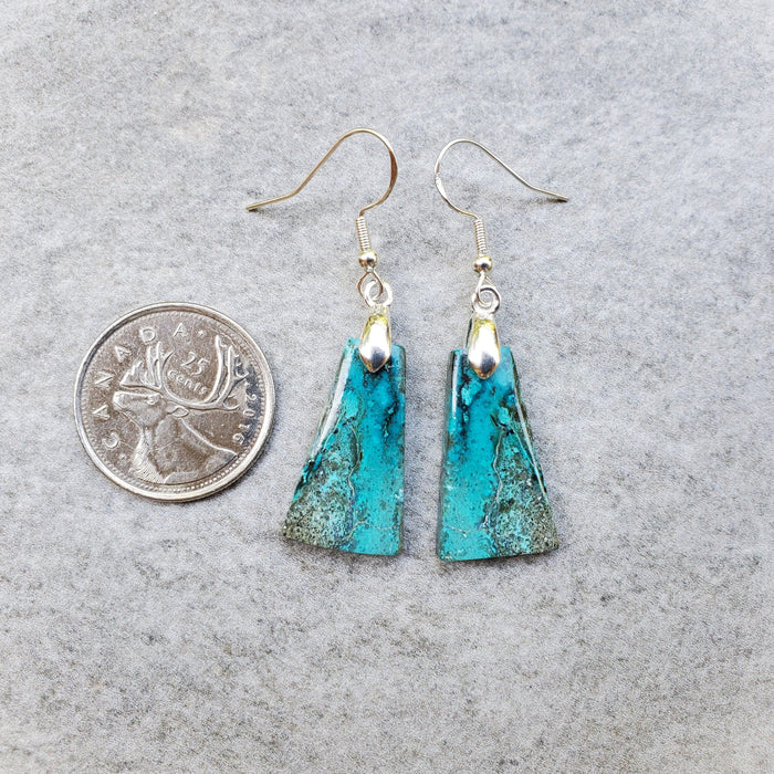 Shattuckite sterling silver earrings beside a quarter