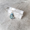 Blue Labradorite teardrop pendant necklace on crystal
