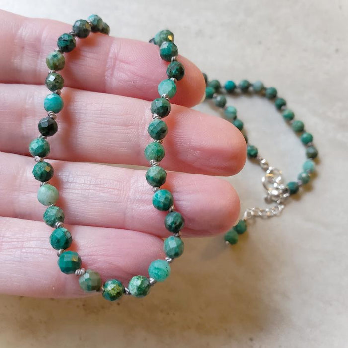 4mm faceted Chrysocolla knotted necklace in hand