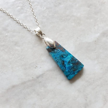 Shattuckite Pendant Necklace with sterling silver chain on tile