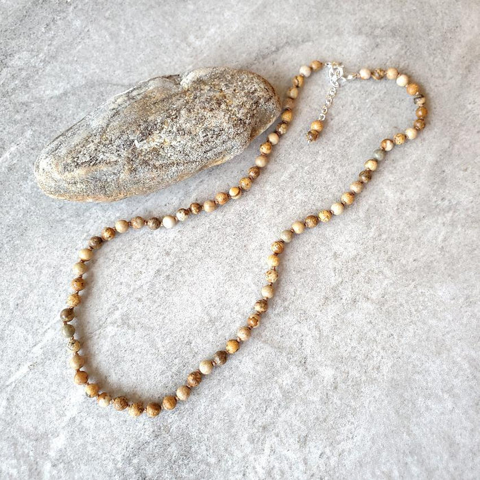 4mm picture jasper knotted necklace on tile