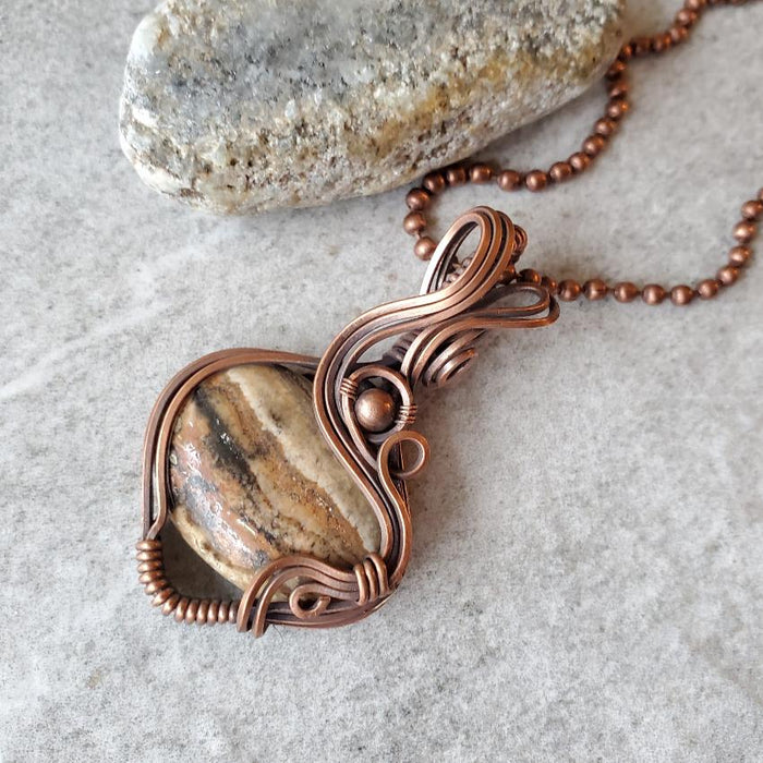 Aragonite wire wrap pendant on tile 