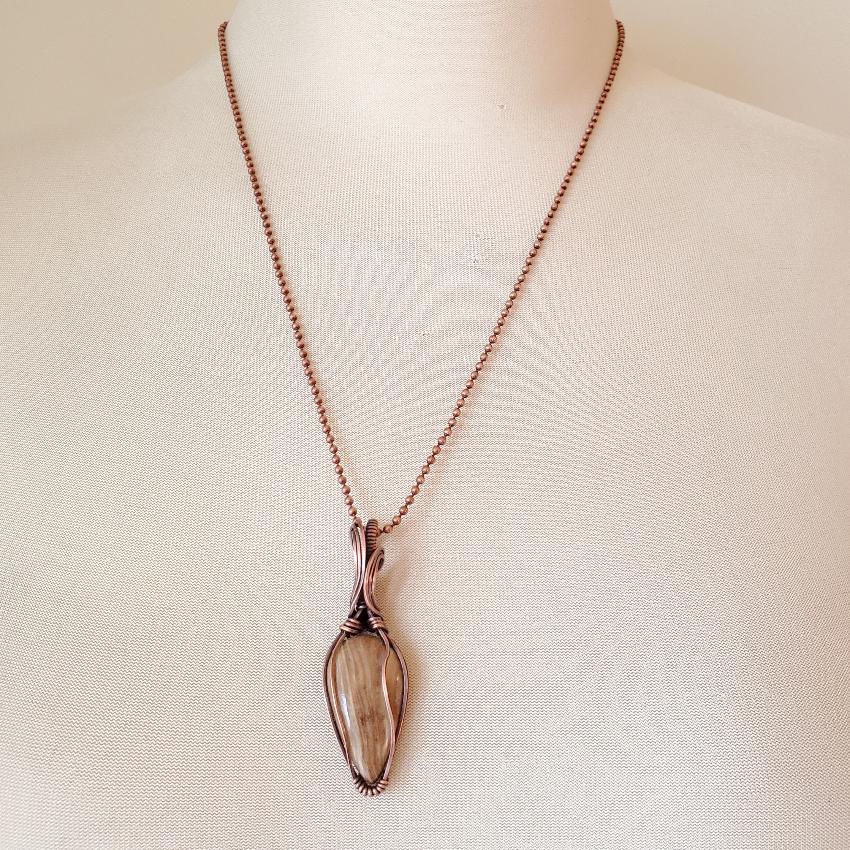 Aragonite wire wrap pendant on bust