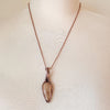 Aragonite wire wrap pendant on bust