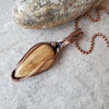 Aragonite wire wrap pendant on tile 