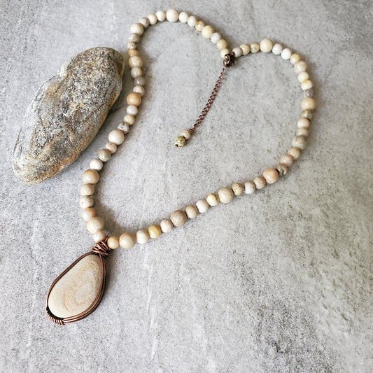 Beach rock focal stone with Fossil Coral necklace on tile 