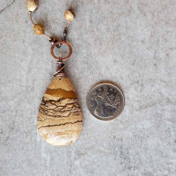 Picture Jasper knotted necklace focal beside a quarter