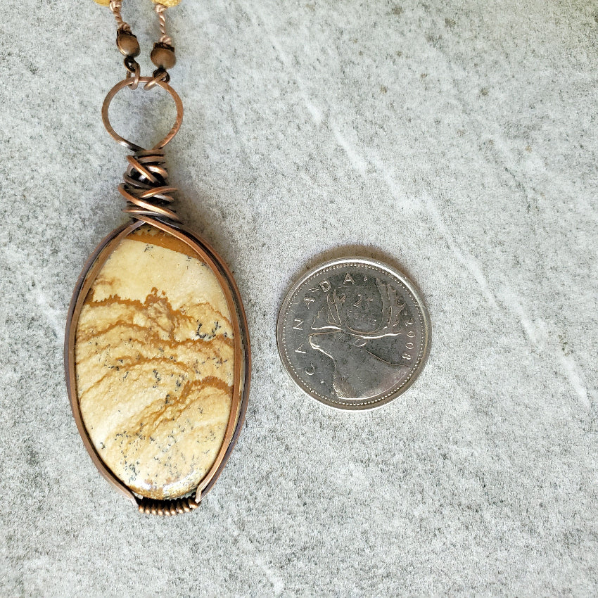 Picture Jasper necklace beside a quarter