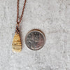 picture jasper teardrop pendant copper necklace beside a quarter