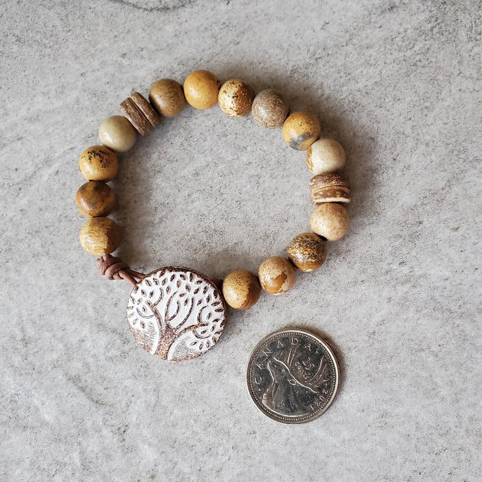 10mm picture jasper leather button bracelet beside a quarter