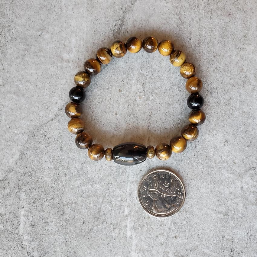 Tiger Eye Golden Obsidian stretch bracelet beside a quarter