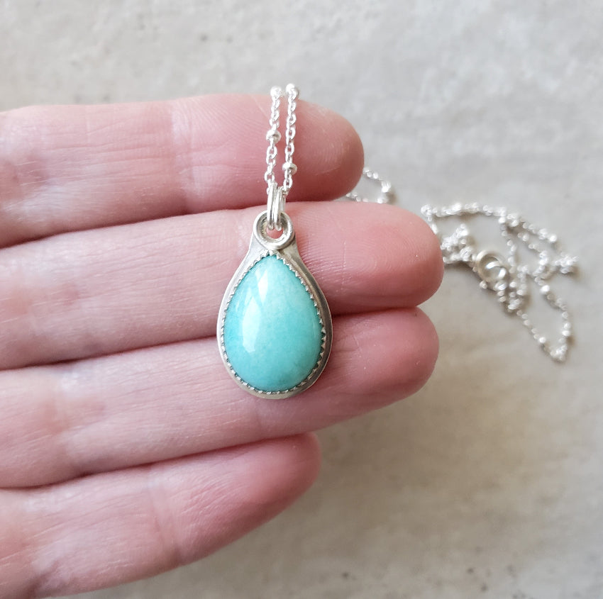 Amazonite teardrop silversmith necklace in hand