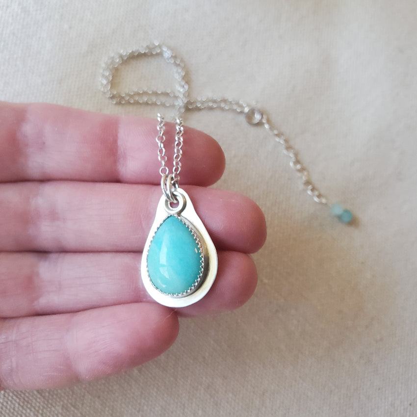 Amazonite teardrop silversmith necklace in hand