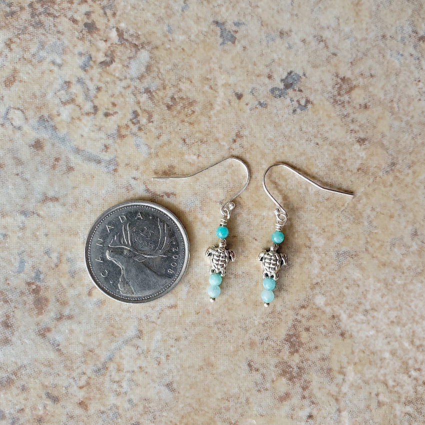Amazonite & Sea turtle bead earrings beside a quarter