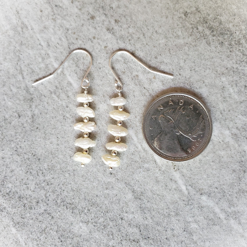 Freshwater Pearl stack earrings beside a quarter