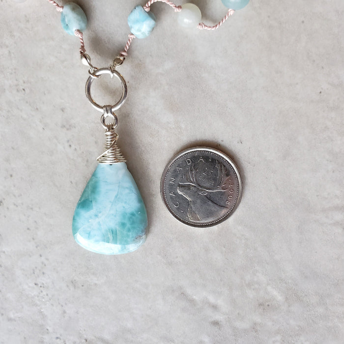 Larimar & Amazonite knotted necklace beside a quarter