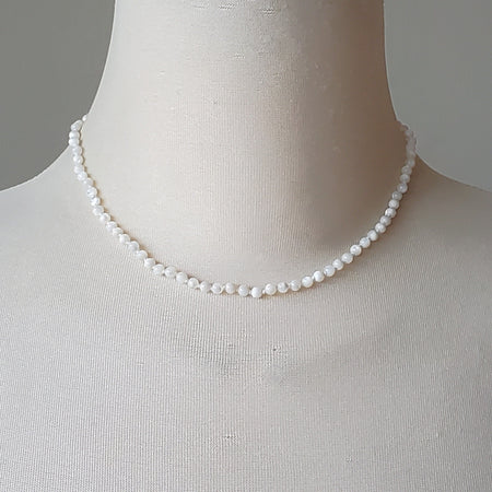 mother of pearl knotted necklace on bust